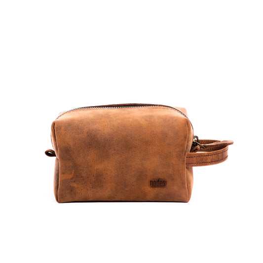 a brown leather toiletry pouch with one big compartment with zipper for travel needs , travel pouch, vanity pouch, leather bag, Genuine leather bag, toiletry pouch,nodes,nodes leather,nodes shop,nodes genuine leather.
