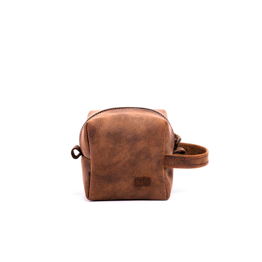 a brown leather toiletry pouch with one big compartment with zipper for travel needs , travel pouch, vanity pouch, leather bag, Genuine leather bag, toiletry pouch,nodes,nodes leather,nodes shop,nodes genuine leather,small size,pocket size,stylish,cosmetics,durable,luxury,leather.