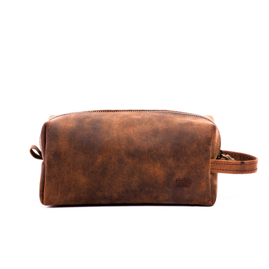 a brown leather toiletry pouch with one big compartment with zipper for travel needs , travel pouch, vanity pouch, leather bag, Genuine leather bag, toiletry pouch,nodes,nodes leather,nodes shop,nodes,genuine leather.