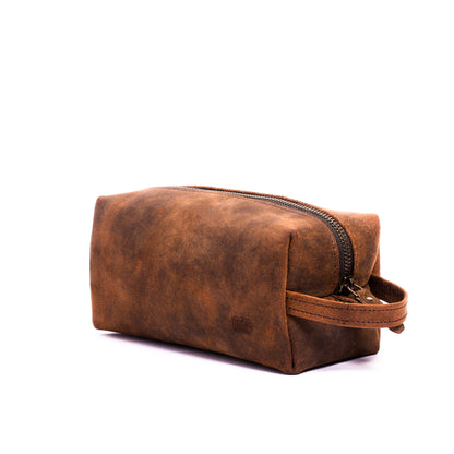 a brown leather toiletry pouch with one big compartment with zipper for travel needs , travel pouch, vanity pouch, leather bag, Genuine leather bag, toiletry pouch,nodes,nodes leather,nodes shop,nodes genuine leather